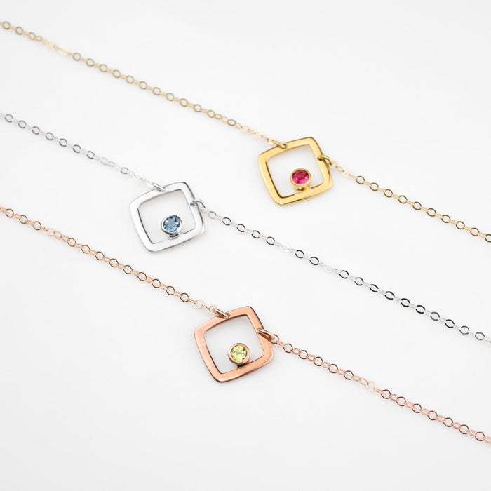 gold plated open square minimalist necklace with ruby birthstone, july birthstone july gemstone. birthstone jewelry. minimalist jewelry. sterling silver open square with iolite birthstone, rolse gold plated open square necklace with peridot birthstone. august birthstone.