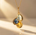 Personalized birthstone necklace for mom with teardrop gemstone charms and engraved names, a meaningful custom family necklace for mothers or grandmothers.