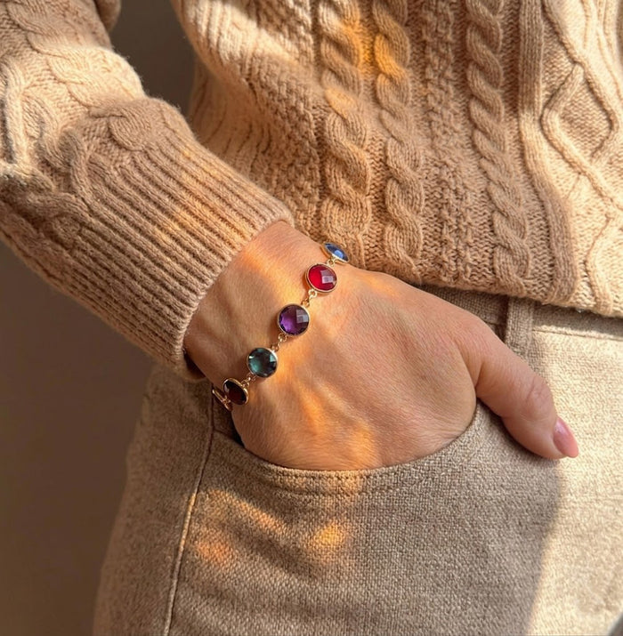 Personalized family birthstone bracelet worn on wrist, a custom bracelet for mom or grandma with colorful gemstones representing children or grandchildren.