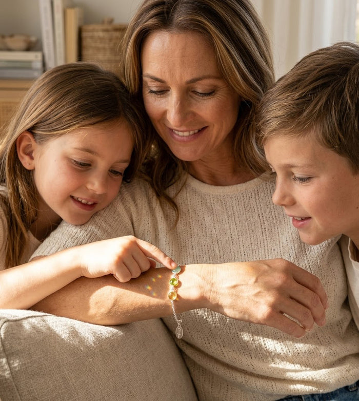 Mother wearing a personalized birthstone bracelet with her children, a meaningful family bracelet gift for mom, grandma, nana, or mimi.