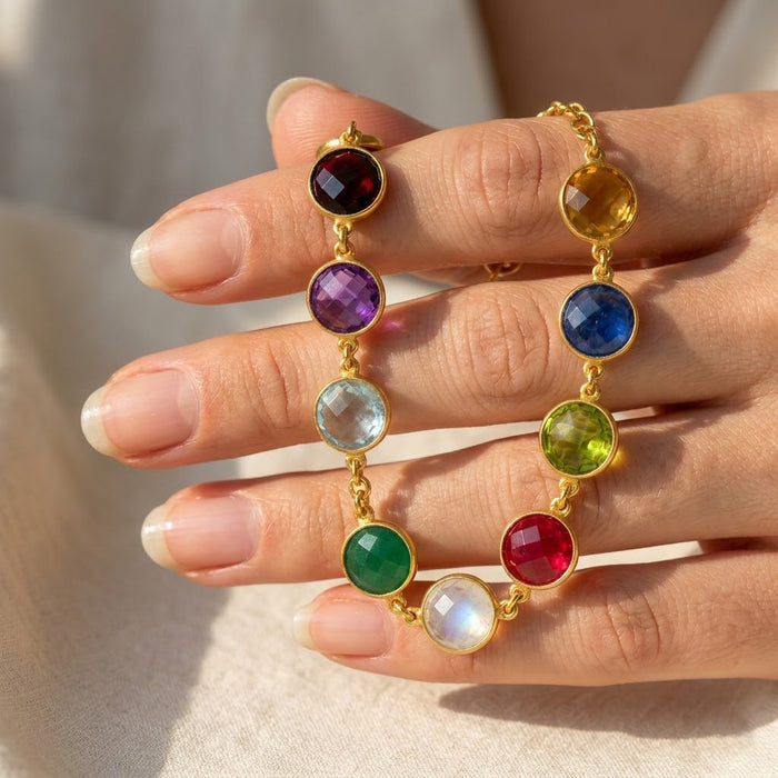 Personalized family birthstone bracelet held in hand, showing colorful gemstone charms for children, grandchildren, or loved ones.