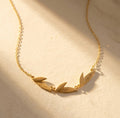 Personalized leaf necklace with engraved names on gold leaf charms, a meaningful custom family necklace for mom or grandma with children’s or grandchildren’s names.