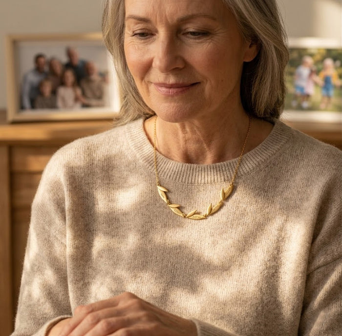 Grandma wearing a personalized leaf necklace with engraved family names, a thoughtful grandmother gift from children or grandchildren.