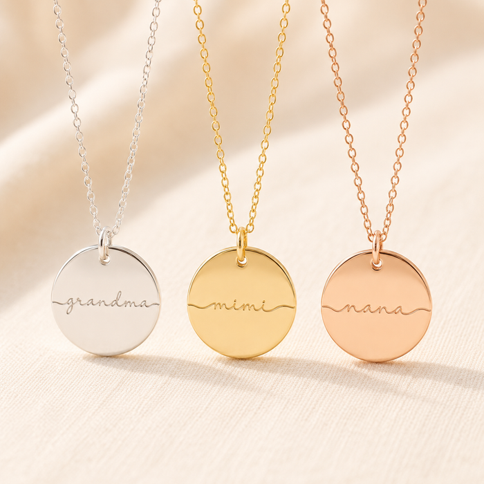 Personalized grandma disc necklace shown in sterling silver, yellow gold filled, and rose gold filled with lowercase script engravings for grandma, mimi, and nana.