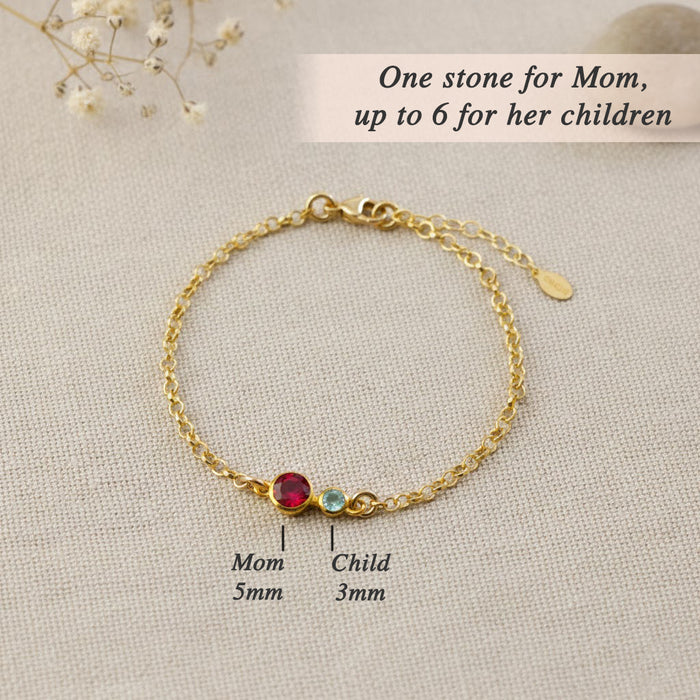 Our rose gold birthstone bracelet for mom highlights a 5mm gemstone representing her and up to six 3mm stones symbolizing her children, creating an elegant family jewelry keepsake full of meaning.