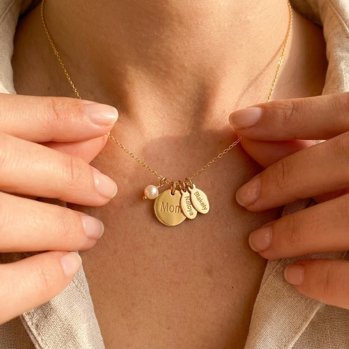 Personalized mother necklace with pearl and engraved name charms shown on model