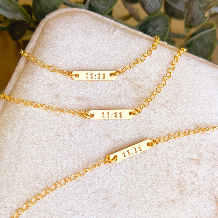 tiny bar bracelet collection featuring several engraved gold vermeil bracelets with personalized dates, names and monograms such as 3.11.11 and 11.21.17, arranged on neutral textured fabric, showcasing the slim minimalist design, adjustable chain options and precision engraving, ideal for customized keepsake jewelry, bridesmaid gifts, meaningful birthday presents or everyday dainty bracelets crafted in sterling silver or 18k gold vermeil