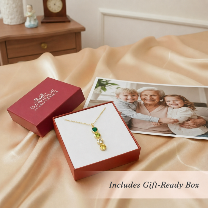 A vertical birthstone bar necklace in an open red Danique Jewelry gift box. Text overlay says Includes Gift Ready Box.