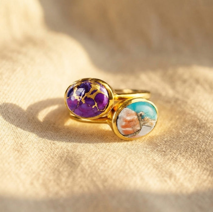 Purple, aqua, and coral cabochon gemstone rings stacked in gold vermeil