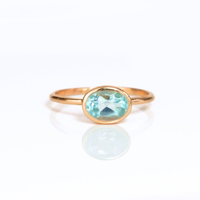 a rose gold blue topaz ring shown on white background. stackable! Stacking rings, bezel set, small oval, tiny oval, dainty oval, birthstone rings, sterling silver stamp, birthstone ring, birthstone jewelry, blue gemstone, blue birthstone, december birthstone, december gemstone