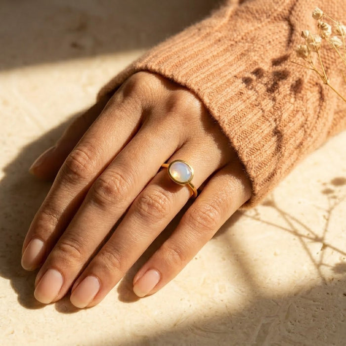Woman wearing opalite ring in gold delicate everyday jewelry