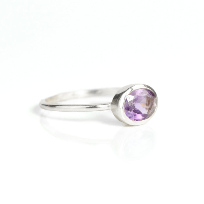 a sterling silver purple amethyst ring shown on white background. stackable! Stacking rings, bezel set, small oval, tiny oval, dainty oval, birthstone rings, sterling silver stamp, birthstone ring, birthstone jewelry, purple gemstone, purple birthstone, february birthstone, february gemstone, purple gemstone, purple birthstone, february birthstone, february gemstone, stack set, stacking rings, gemstone ring, birthstone ring, mother's day gift for her, gift for mom, gift for fiance, gift for girlfriend