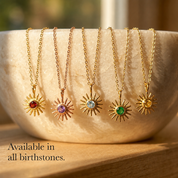 Custom birthstone sunburst necklaces shown in all birthstone colors on gold chains