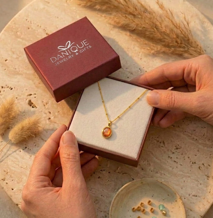 Gift-ready sunstone necklace displayed in a Danique Jewelry box, featuring an oval orange gemstone pendant packaged for birthdays or gifts for her.