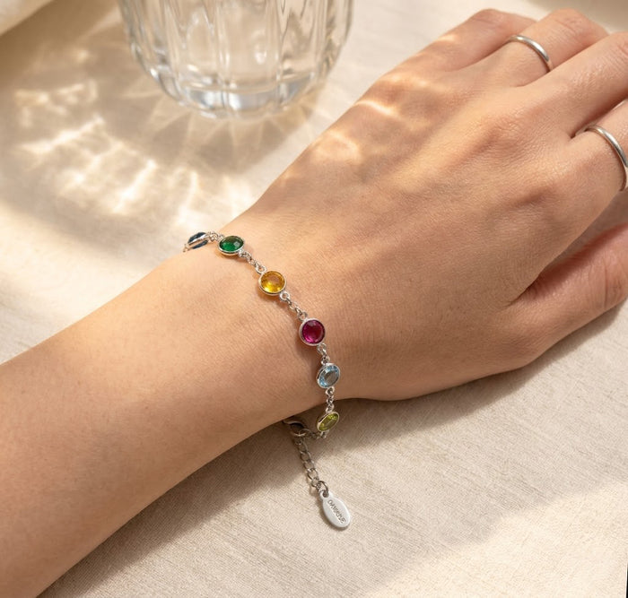 dainty birthstone bracelet on wrist with colorful 6mm gemstones, personalized family jewelry gift for her
