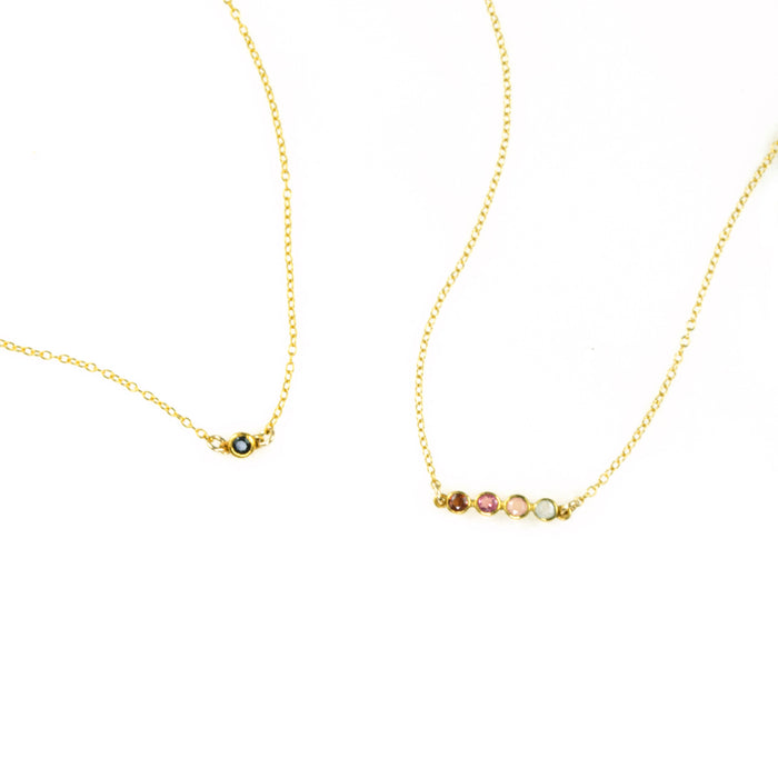 One gold filled black onyx birthstone connector necklace. One four stone dainty birthstone necklace featuring garnet, ruby, pink chalcedony and aqua chalcedony.