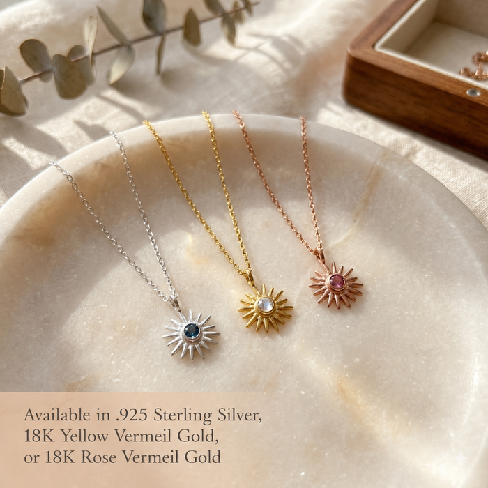 Three tiny birthstone necklaces displayed in sterling silver, yellow gold, and rose gold finishes with delicate gemstone pendants.
