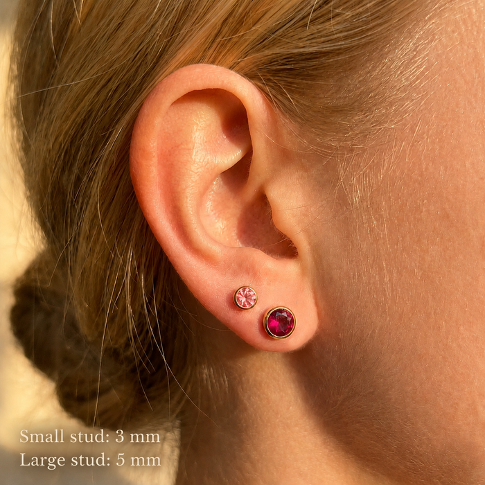 Model wearing two birthstone stud sizes showing 3mm and 5mm earrings for first or second piercings
