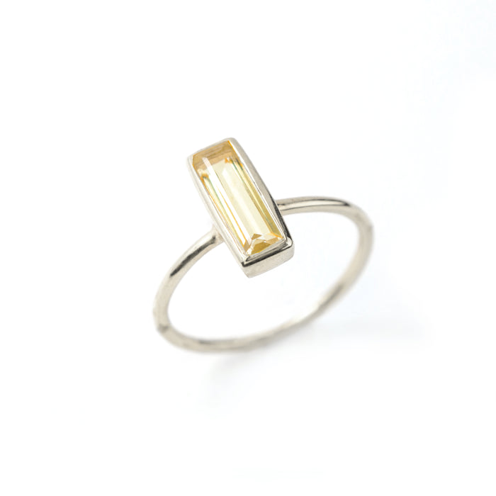 Sterling Silver tiny gemstone adira bar ring with citrine birthstone on white background.