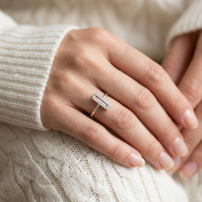Clear quartz bar ring on soft background, faceted crystal rectangle gold ring