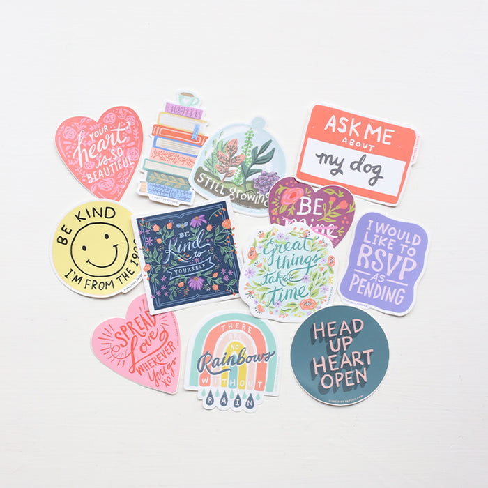 Collection of colorful vinyl stickers with various designs and messages on a white background