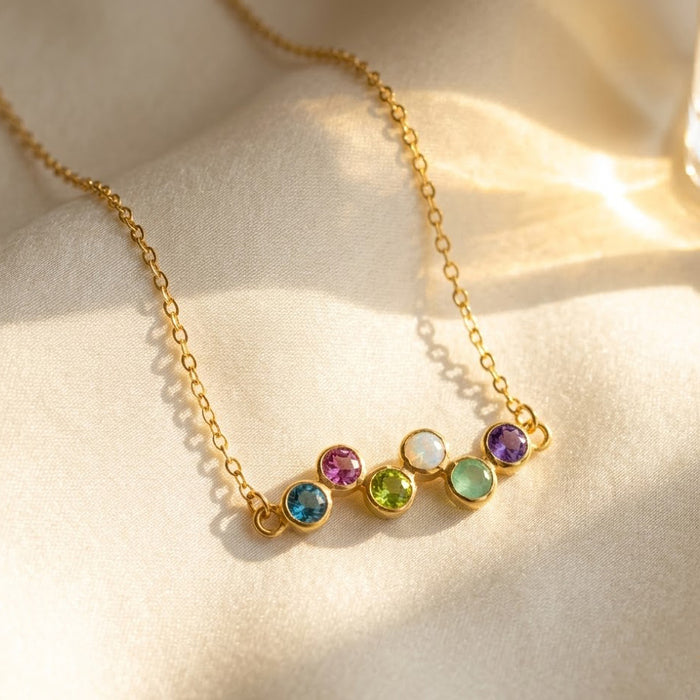Zigzag birthstone necklace with colorful round gemstones on a delicate gold-filled chain, personalized with up to six stones for kids or grandkids.