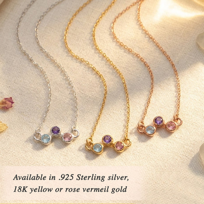 Custom birthstone necklace worn on model, featuring a delicate zigzag gemstone design for children’s birthstones or family stones shown in sterling silver or rose gold.